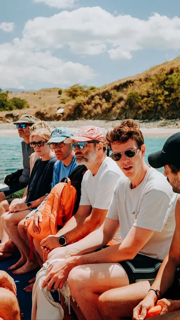 Guests aboard a boat trip near a secluded beach in Komodo National Park
