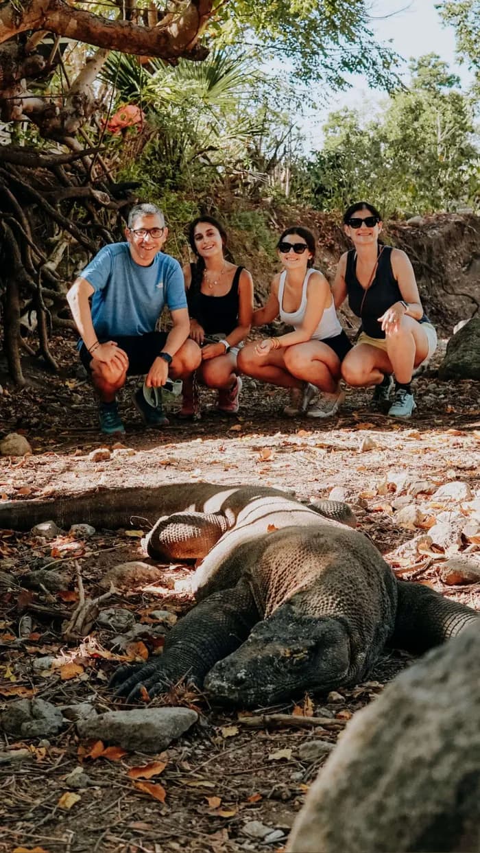 Family encountering a wild Komodo dragon up close in Komodo National Park