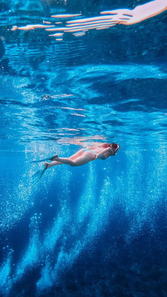 Underwater snorkeling in the deep blue water of Komodo National Park